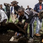 Relatives and friends cover a grave during a funeral for a victim of violence from M23 in Goma, Democratic Republic of Congo.