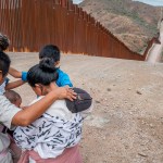Migrant family praying at US border