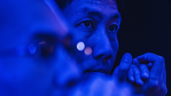 A photo of a tech engineer with blue lighting