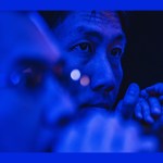 A photo of a tech engineer with blue lighting