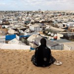 A woman overlooks a camp for displaced people in the southern Gaza Strip, on September 29, 2025, as the conflict between Israel and Hamas continues.