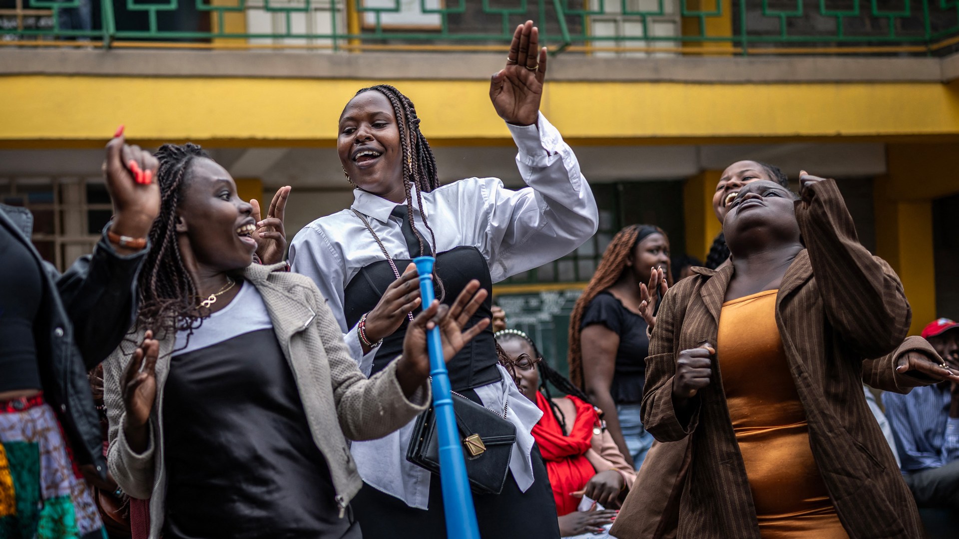 Young attendees dance and sing on church grounds in the Kibera informal settlement of Nairobi.