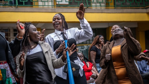 Young attendees dance and sing on church grounds in the Kibera informal settlement of Nairobi.