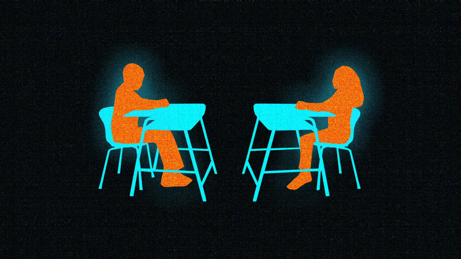 Two students sitting at desks facing each other.