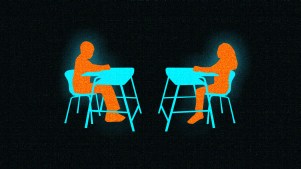 Two students sitting at desks facing each other.
